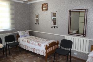 Ένα ή περισσότερα κρεβάτια σε δωμάτιο στο Tian-Shan Guest House