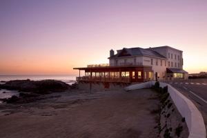 a house on the beach at sunset at Grand Hotel de L'Océan in Le Croisic