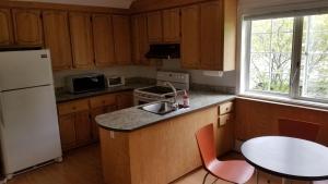 eine Küche mit einem weißen Kühlschrank und einem Tisch in der Unterkunft Appartement près des Plaines d'Abraham in Québec