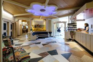 a store with a lobby with a large chandelier and a room with at Hotel Rex in Bad Wiessee