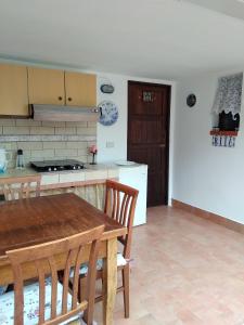 a kitchen with a wooden table and a dining room at Heart of Castellammare in Castellammare del Golfo