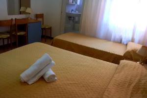 Letto o letti in una camera di Hotel Loreto