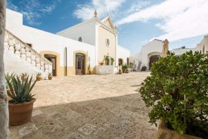 an external view of a church with a courtyard at Masseria Borgo San Marco in Fasano