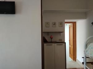 a room with a kitchen with a counter and a door at Heart of Castellammare in Castellammare del Golfo