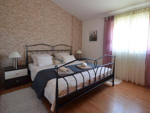 a bedroom with a bed and a brick wall at Apartman Daniela in Split