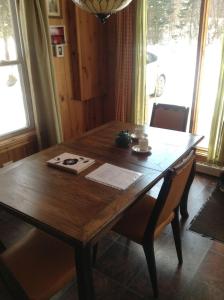 a wooden dining room table with chairs and a window at Chalet d'Anna in Saint-Damien +27 photos
