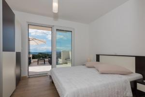 Posteľ alebo postele v izbe v ubytovaní Apartments Villa Hadria
