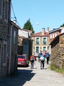 a group of people walking down a street at Casa Carlán in Melide