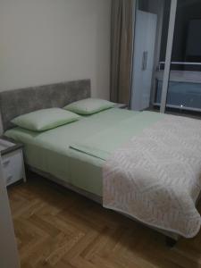 a bedroom with a bed and a window at Vlado Apartment in Belgrade