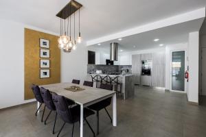 a dining room and kitchen with a table and chairs at Ta Martin, Flat 2 in St. Paul's Bay