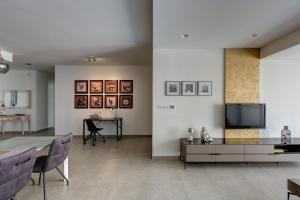 a living room with a table and a tv at Ta Martin, Flat 2 in St. Paul's Bay