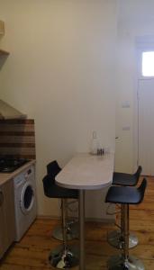 a kitchen with a table and chairs in a room at Sololaki Dadiani in Tbilisi City