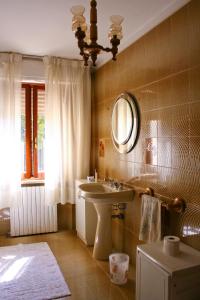 a bathroom with a sink and a mirror at Morianese Residence in Lucca