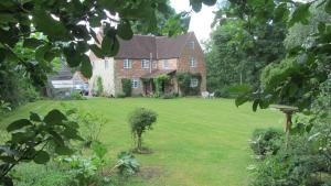 a large brick house with a large green yard at Milton Farm in East Knoyle