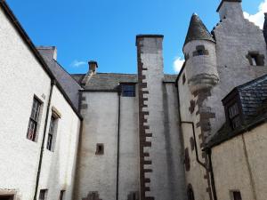 an old castle with a tower and a turret at Hallgreen castle in Inverbervie