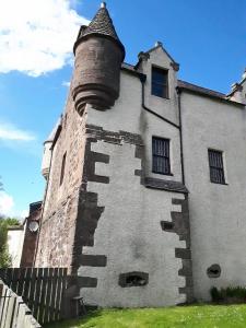 an old building with a chimney on the side of it at Hallgreen castle in Inverbervie