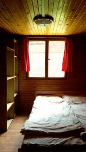 a large bed in a room with a window at Chata U Jozefa in Malý Lipník