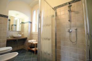 a bathroom with a shower and a toilet and a sink at B&B U Campanin in Dolceacqua