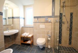 a bathroom with a toilet and a sink and a shower at B&B U Campanin in Dolceacqua