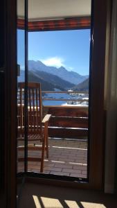 a door to a balcony with a view of the water at Spectacular View & Central Location in Davos in Davos