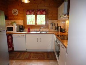 a small kitchen with a sink and a microwave at Le Chalet de Philippe in La Bresse +15 photos