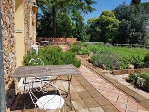 un tavolo in legno e sedie in giardino di Agriturismo Bio Fattoria di Pietra a Giuncarico