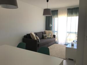 a living room with a couch and a table at JP House in Figueira da Foz +5 photos