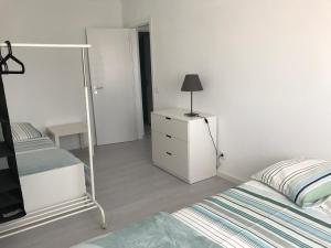 a bedroom with a bed and a dresser and a mirror at JP House in Figueira da Foz