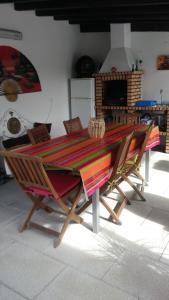 a wooden table with two chairs around it at Casa da Boa Agua 1 in Quinta do Conde