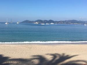 a view of a beach with boats in the water at 7Art Hotel in Cannes