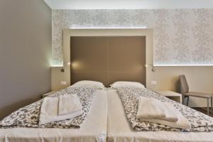 Postel nebo postele na pokoji v ubytování Hotel Gardesana