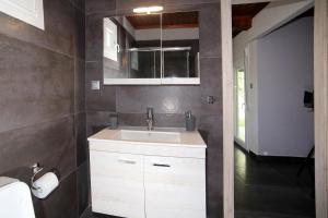 a bathroom with a white sink and a mirror at House Loana in Neos Marmaras +18 photos