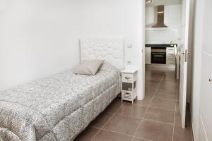 a bedroom with a bed and a tiled floor at Apartamento Victoria in Puerto del Carmen
