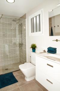 a bathroom with a toilet and a sink and a shower at Apartamento Victoria in Puerto del Carmen +12 photos