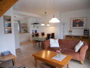 a living room with a couch and a table at La Tulipe **** in Savines