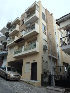 a building with a car parked in front of it at Lion Apartment Sunset in Thessaloniki