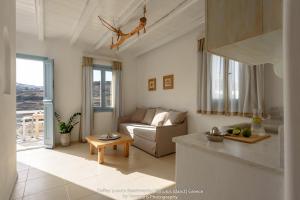 a living room with a couch and a table at Toffee in Kimolos