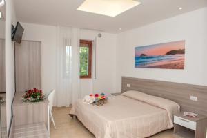 Un pat sau paturi într-o cameră la Albergo San Giorgio