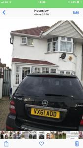 a black car parked in front of a house at House in Hounslow