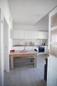 a kitchen with a wooden table in a room at Apartment Villa Bralo in Trogir