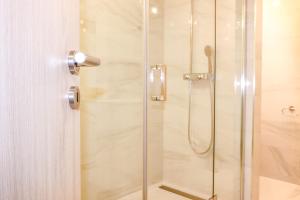 a shower stall with a glass shower door at Apartment Bugenvilija in Lovran