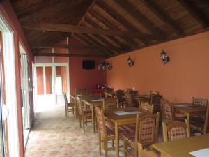 a dining room with wooden tables and chairs at Guest House Villa Živanović in Herceg-Novi
