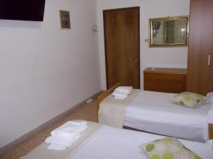 a bedroom with a bed and a dresser at Victoria in Catania