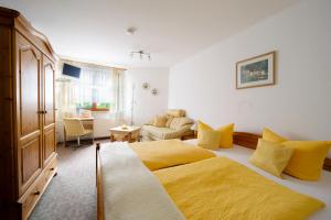 a bedroom with two beds and a living room at Landpension Risch in Ilmenau