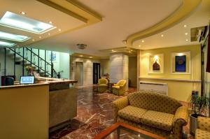 a lobby with couches and a bar in a building at Hotel Nefeli in Volos