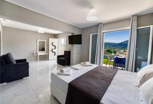 a hotel room with a bed and a balcony at Ponti Beach Hotel in Vasiliki