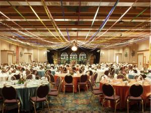 a banquet hall filled with tables and chairs at Inn of the Hills Hotel and Conference Center in Kerrville +28 photos