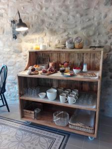a shelf with food on it in a room at Can Parés in Sant Gregori