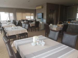 a dining room with tables and chairs in a restaurant at Kent Hotel in Samsun