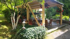 einen Pavillon mit einem Tisch und Stühlen im Garten in der Unterkunft Green Garden in Šip